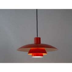 an orange and red light hanging from a ceiling