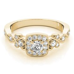 a yellow gold engagement ring with diamonds on the sides and an intricate band around it