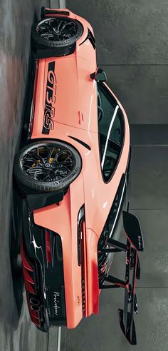 an orange sports car parked in a parking garage with wheels on it's roof