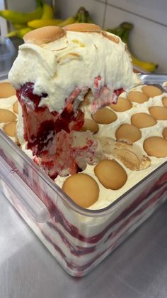 a cake in a plastic container with eggs around it and one slice missing from the cake