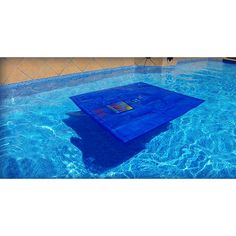 a blue towel sitting on top of a swimming pool