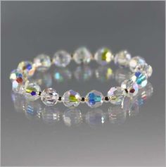 Sparkle Alert! This bracelet shimmers and shines with every movement you make. It is made with large crystal beads that have an aurora borealis coating to give it a rainbow sparkle. Nestled in between each crystal is a sterling silver bead. This bracelet is made using stretch material and measures 7 inches in length before closure. There are additional sizes and options for a lobster clasp for an additional cost. Diy Jewelry Making Tutorials, Rainbow Sparkle, Fusion Beads, Sparkle Bracelet, Swarovski Crystal Jewelry, Swarovski Crystal Bracelet, Large Crystal, Swarovski Crystal Beads, Beaded Bracelet Patterns