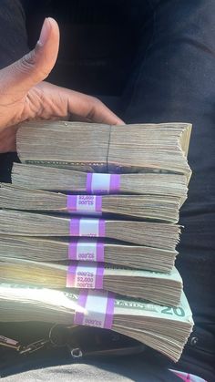 a person holding stacks of money in their hands