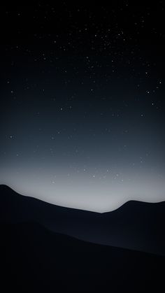 the night sky is lit up with stars above mountains and hills in the foreground