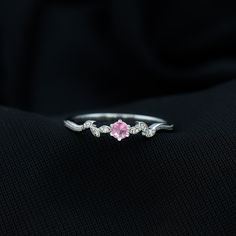 a close up view of a pink diamond ring