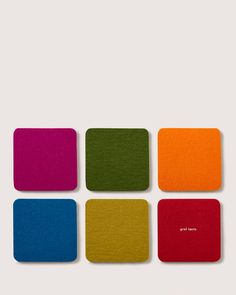 four square coasters with different colors on them