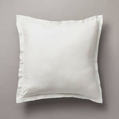 a white pillow on a gray wall