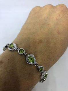 This Peridot bracelet is very lively and bright. The stones are deep colors and well matched. The sterling silver is plated with rhodium to protect the bracelet from tarnish and give the appearance of white gold. 7.5 inches My jeweler can shorten it All jewelry is shipped in a nice gift box. Check out our over a THOUSAND great reviews Engraving is $4 per letter and is not always perfect depending on the piece. It can take a few days if the jeweler is busy. This is payable to Paypal Judithsltd@gm Green Multi-stone Round Bracelets, Sterling Silver Bracelet With Green Gemstone, Green Oval Sterling Silver Bracelet, Oval Green Sterling Silver Bracelet, Green Oval Sterling Silver Bracelets, Green Round Sterling Silver Bracelet, Anniversary Green Sterling Silver Bracelets, Green Multi-stone Bracelets For Gifts, Green Gemstone Diamond Bracelet