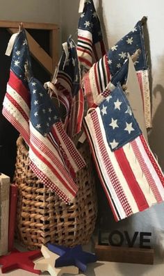 an american flag is hanging from a basket next to other patriotic items and books on a shelf