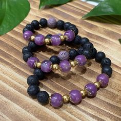 "These one of a kind Diffuser Bracelets are made with Volcanic Lava Rock beads which are a naturally porous stone perfect for absorbing your favorite essential oils. This series boasts shimmering purple hand made resin beads, gold spacer beads, and black lava rock beads with one purple lava rock bead to match. The resin beads glow a gentle purple after being exposed to sunlight or other bright lights.  Aromatherapy is a natural way to increase feelings of health and wellbeing.  Handcrafted resin beads are created individually with UV resin, mica, alcohol inks and tints, some with natural black sand and ocean pebbles, glow in the dark pigments, gold leaf flakes or gold stone chips.  These bracelets are on a stretchy elastic .8mm cord. Measure your wrist and add .5\" for snug fit or 1\" for Healing Lava Stone Bracelets With Gemstone Beads, Healing Bracelet With Gemstone Beads And Lava Stone, Spiritual Lava Stone Stretch Bracelet With Natural Stones, Healing Lava Stone Beaded Bracelets, Bohemian Lava Stone Bracelets For Gift, Bohemian Lava Stone Bracelet As Gift, Adjustable Lava Stone Beaded Bracelets With Natural Stones, Bohemian Lava Stone Beaded Bracelets Gift, Spiritual Lava Stone Stretch Bracelet Gift