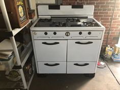 an old fashioned white stove with two ovens