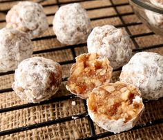 several desserts sitting on a cooling rack with powdered sugar and cinnamon in the middle