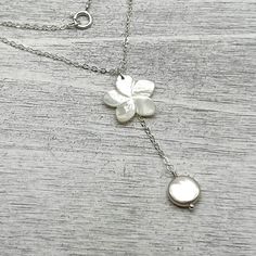 Adjustable Mother Of Pearl Necklace With Pearl Pendant, Adjustable Mother Of Pearl Necklace With Pendant, Elegant Flower-shaped Mother Of Pearl Necklace, Elegant Adjustable Shell Necklace With Pearl Pendant, Elegant Flower Necklace With Pearl Charm, White Pearl Drop Flower Pendant Necklace, White Flower Pendant Necklace With Pearl Drop, Flower-shaped Pearl Pendant Necklace As Gift, Flower Shaped Pearl Pendant Necklace As Gift