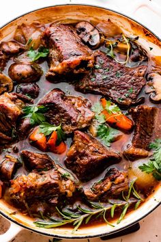 a pot filled with meat and vegetables on top of a table