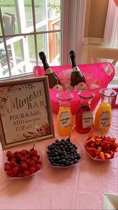 a table topped with fruit and drinks next to a sign that says muncha bar