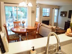 a kitchen and living room are shown in this image, with the dining area to the side