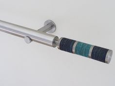 a close up of a towel rack with rings on it's end and two towels hanging from the top