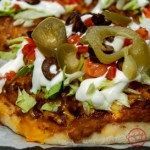 several small pizzas with toppings sitting on top of a paper wrapper, ready to be eaten