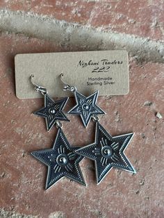 Be unique and stylish with the Star Gazer Dangle Earrings! Offering an eye-catching western look, these earrings have the perfect mix of chic and statement style. Make a memorable style statement with this unique jewelry! Stamped Sterling Silver 2.5 " L X 1.5" W Non-Native Metal Dangle Earrings With Star Charm, Bohemian Silver Star Earrings, Star-shaped Earrings With Dangling Charms For Gift, Bohemian Silver Star-shaped Earrings, White Bin, Adjustable Star-shaped Sterling Silver Earrings, Horse Hair Pottery, Western Look, Sterling Silver Dangle Earrings