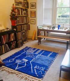 a living room filled with furniture and a blue rug