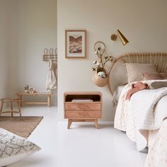 a bed room with a neatly made bed next to a night stand and two nightstands