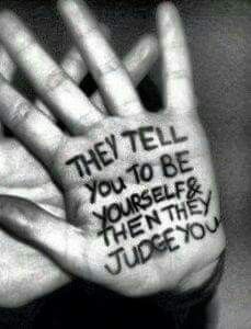 two hands with writing on them that say they tell you to be yourself and then they judge you