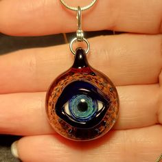 "Eyes have always been a fascination of mine. I make each handmade blown glass eye pendant using a blowtorch and Borosilicate glass in my studio. Some people refer to these eye pendants as Evil Eye Pendants. The evil eye has always been an ancient symbol that brings protection and good luck from any negative energy. I just like making eyes that look realistic, and glow from the silver in the glass. A lot goes into making these Evil Eye Pendants. First, I must create a murrini cane with the pupil Glass Eyes, Evil Eye Pendant, Ancient Symbols, Evil Eye Necklace, Eye Necklace, Evil Eye, Handmade Necklaces, Belly Button Rings, Fascinator