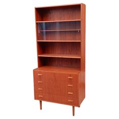 a wooden bookcase with two drawers on one side and an open drawer on the other