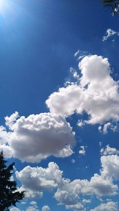 the sun shines brightly on some clouds in the blue sky