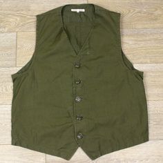 NEEDLES REBUILD BDU waistcoat XL 50/50 cotton sateen olive green nepenthes EUC Up for sale is a Needles Rebuild BDU waistcoat/vest. Each piece in this line is totally unique. Olive green 50/50 cotton sateen panels salvaged from vintage military uniforms.  5-button front placket and buckle adjuster on rear. Tagged size XL, see measurements below. Measurements (inches): Shoulder to Shoulder (across top of vest, shoulder seam to shoulder seam): 14.25 Pit to pit (on front): 21 Length (bottom of coll Casual Green Cotton Vest, Casual Khaki Cotton Vest, Green Casual Cotton Vest, Utility Cotton Sleeveless Tops, Green Cotton Utility Top, Green Buttoned Vest For Workwear, Green Cotton Goblincore Top, Khaki Cotton Vest Outerwear, Green Sleeveless Cotton Outerwear