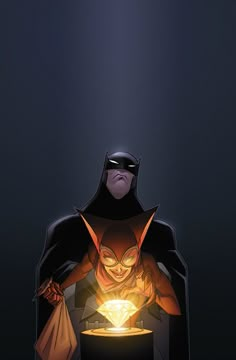 a man in a batman costume is holding a glowing lantern and looking at the viewer