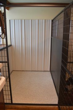 the inside of a caged in area with a sink and towel dispenser