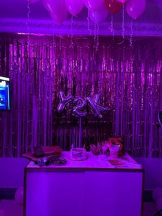 a purple party with balloons and streamers