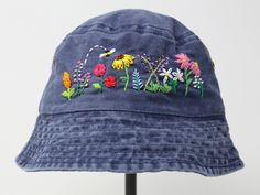 Item: flower embroidered bucket hat Material: 100% cotton Size: one size fits most Embroidery: hand made with acrylic thread Free first class shipping, upgradable priority mail service. 30 days return policy, feel confident at your purchase! Whimsical Cotton Hats For Spring, Summer 5-panel Hat With Embroidered Logo, Summer Embroidered Logo 5-panel Hats, Adjustable Embroidered Cotton Sun Hat, Spring Outdoor Hat With Embroidered Logo, Custom Embroidered Cotton Summer Hats, Spring Wide Brim Bucket Hat With Embroidered Logo, Custom Embroidered Cotton Hats For Summer, Adjustable Embroidered Cotton Hat