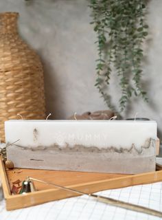 a wooden box with some plants in it on a table next to a planter