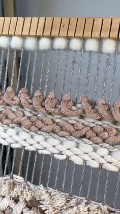 two hands that are on some kind of weaving