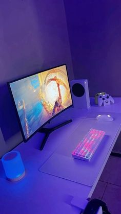 a computer monitor sitting on top of a white desk next to a keyboard and mouse