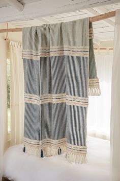 a blue and white striped curtain hanging from the ceiling