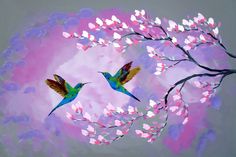 two hummingbirds flying in the sky near a tree with pink flowers and white leaves