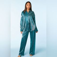 A Knit Set Featuring A Shirt With A Basic Collar, Button-Front Closures, Allover Ribbed Construction, Dropped Long Sleeves, Dolphin Hem, And A Metallic Finish, As Well As A Matching Pair Of Pants With A High-Rise Elasticized Waist And Wide Leg. Bust Is 25 Inches Across (Oversized). Small Waist Is 13.5 Inches. Medium Waist Is 15 Inches. This Is Fantastic! I Kept One And Wore It For New Years. So Pretty. So Comfy. Lots Of Compliments. Small Inventory Box #V22 Medium Inventory Box #V23 Blue Buttoned Tops For Loungewear, Chic Blouse With Buttons For Loungewear, Oversized Blouse For Loungewear With Button Closure, Oversized Loungewear Blouse With Button Closure, Blue Button-up Blouse For Loungewear, Blue Relaxed Fit Blouse For Loungewear, Relaxed Fit Blue Blouse For Loungewear, Long Sleeve Blouse For Loungewear With Buttons, Long Sleeve Blouse For Loungewear