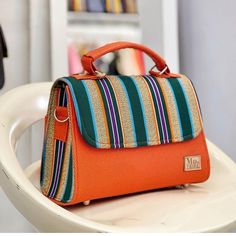 "Batakari bag. Made with handmade weaved multicoloured Fugu fabric with quality leather combination  It is made with Hand weaved fabric (Fugu); a type of fabric from the Northern Region of Ghana. It has a top zipper closure and inner side pocket. Dimensions/Size : L- 8\", W-5'- H-6\"" Multicolor Box Bag With Detachable Strap For Everyday Use, Multicolor Top Handle Box Bag For Daily Use, Woven Fabric Bags For Everyday Use, Everyday Woven Fabric Shoulder Bag, Multicolor Shoulder Satchel For Market, Multicolor Top Handle Box Bag With Adjustable Strap, Rectangular Woven Fabric Shoulder Bag, Multicolor Square Satchel With Detachable Strap, Multicolor Fabric Shoulder Bag For Everyday