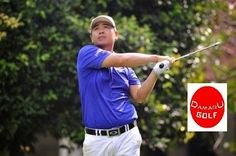 a man swinging a golf club on top of a green field