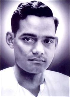 a black and white photo of a man with short hair wearing a shirt and tie