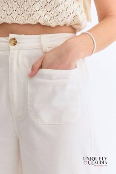 The Kelly Off-White Culotte Pants are high-waisted with a flattering wide-leg silhouette. They feature convenient front pockets and chic faux pockets at the back, adding a touch of sophistication. The front zipper closure and belt loops offer a versatile fit, while the lightweight, woven fabric ensures comfort without compromising on style. These non-sheer pants are unlined, making them perfect for any season. - Unlined - 97% Cotton, and 3% Spandex - Wash Cold. Do Not Bleach. Line Dry. - Importe Sheer Pants, Culotte Pants, Denim Top, High Waisted Pants, Long Tops, Short Tops, Dress Collection, Front Zipper, Jumpsuit Dress