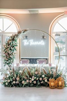 a table with flowers and greenery on it