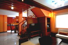 a living room filled with furniture and a flat screen tv sitting on top of a wooden shelf