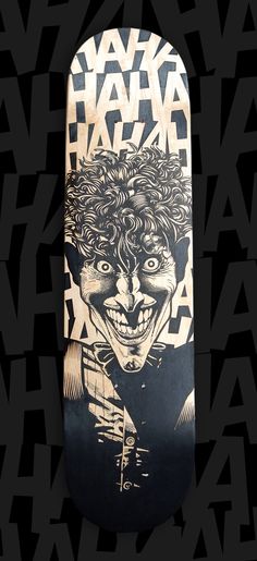 a skateboard with an image of a clown on it's face and the words,