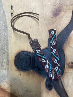 7/8" hatband. All bead work is beaded with 10lb extreme braided nylon line.  All hat bands are finished at 23" with glued than sewed down leather ends and an adjustable leather tie. These hatbands make the perfect edgy new accessory while at work or while horseback riding. Made in Montana. Would make the perfect gift. Ready to ship! Hat Band Beaded, Artisan Beaded Hat Bands For Festivals, Hat Bands Diy, Black Beaded Hat Band For Beach, Beaded Two Feather Hat Band, Hat Bands Diy Ideas, Traditional Multicolor Beaded Hat Band, Beaded Hats, Helena Montana