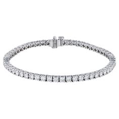 Experience timeless glamour with a stunning Round Brilliant Diamond White Gold Tennis Bracelet. 18kt white gold crafted with 58 pristine round brilliant cut diamonds. Four prong setting for a luxurious look. Handmade by H&H Jewels. Round Brilliant Diamond White Gold Tennis Bracelet 18kt. White Gold Tennis Bracelet 58pcs Round Brilliant Cut Diamonds 5.19ct TW F/G VS1 (EX,EX) 4 prong setting Handmade H&H Collection SKU: 21664 Gold Tennis Bracelet, Bracelet Tennis, Modern Bracelets, American Modern, Brilliant Diamond, Tennis Bracelet, Round Brilliant Cut Diamond, Round Brilliant, Diamond White