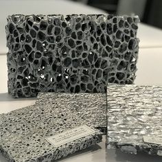 three different types of tile sitting on top of a white table next to each other